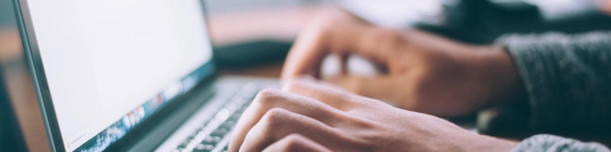 image of man typing on laptop