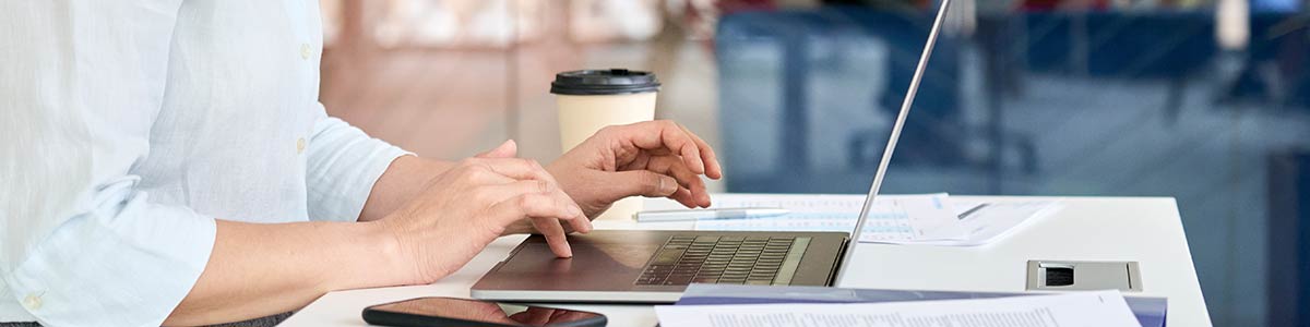 image of woman's hands using laptop